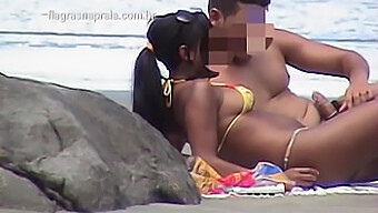 A Young Brunette Gets Intimate On The Beach With Her Lover